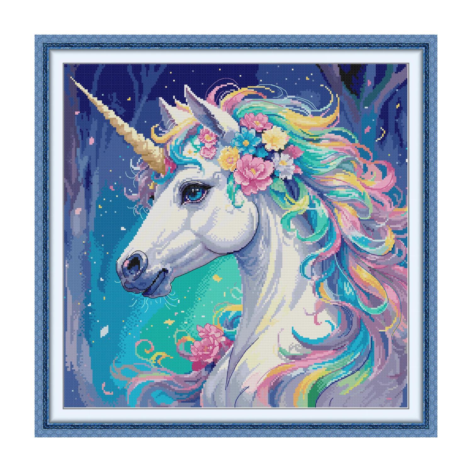 Unicorn cross stitch design with a rainbow mane and pink flowers on a deep blue background