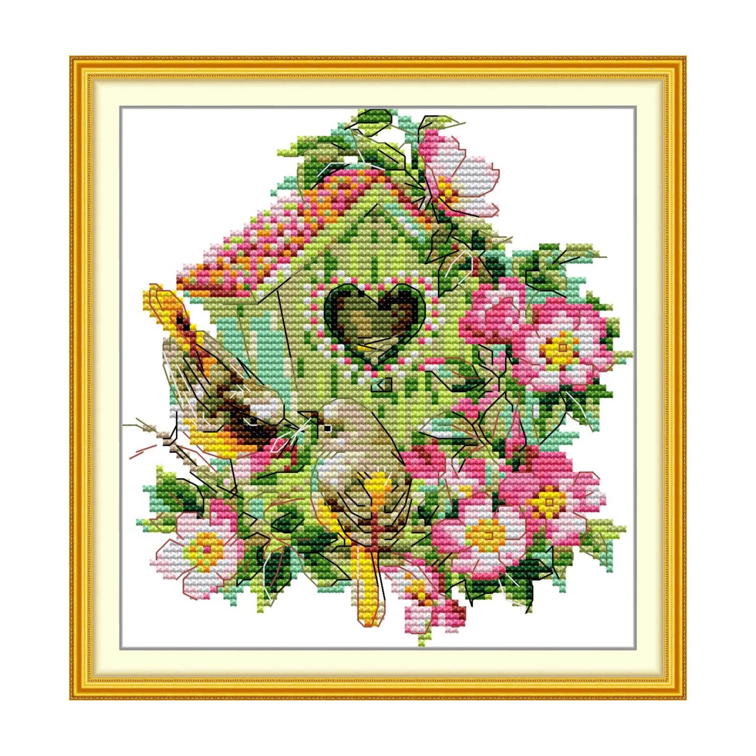 Bird cross stitch design of two birds beside a heart-shaped birdhouse surrounded by pink wild roses