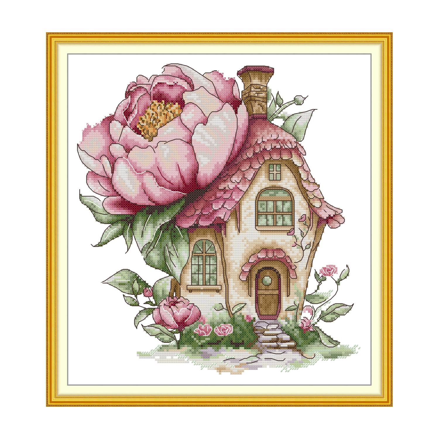 Floral cross stitch design of a fairy tale cottage with a large pink peony flower roof and climbing roses
