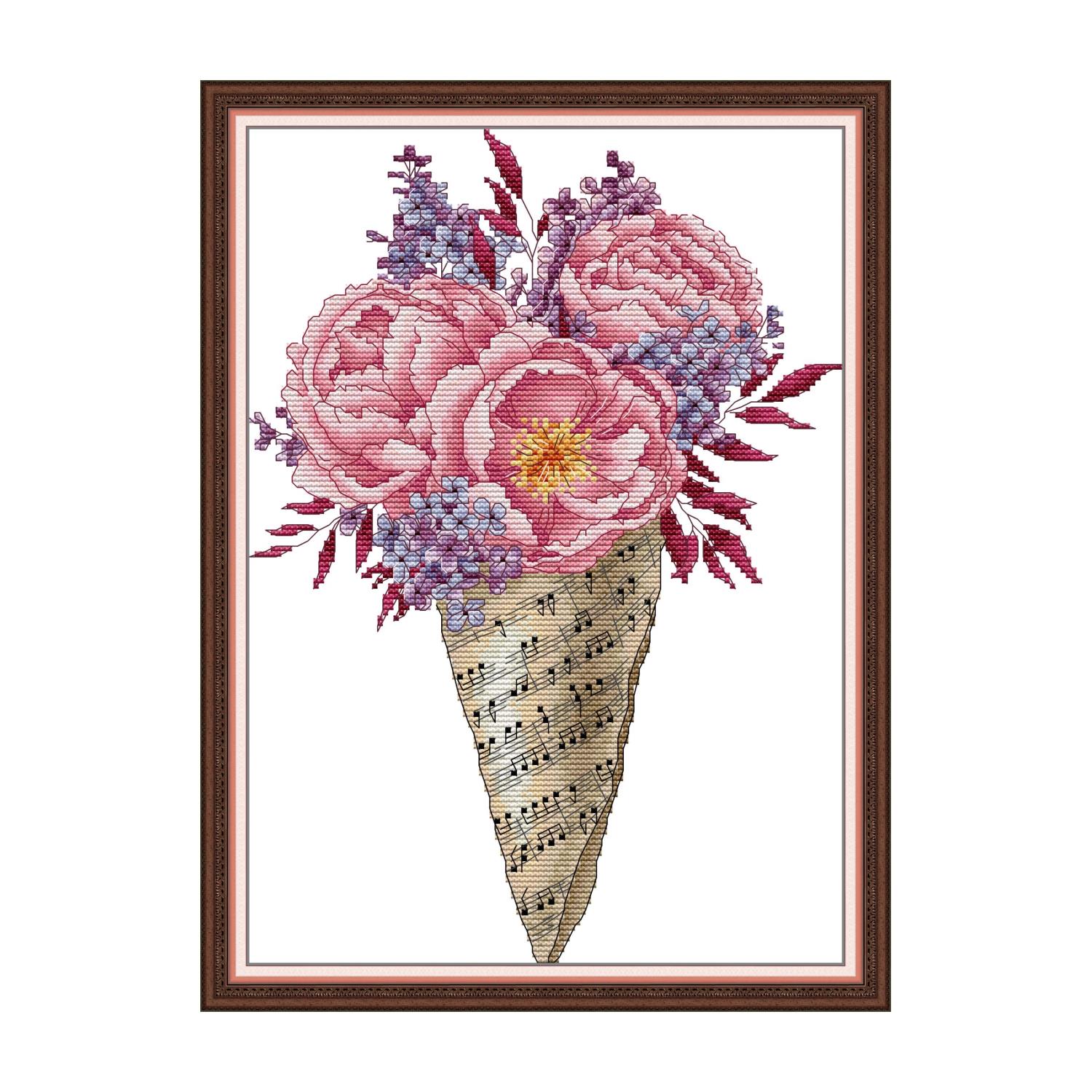 Floral cross stitch design of a pink peony bouquet wrapped in sheet music paper with purple accent flowers