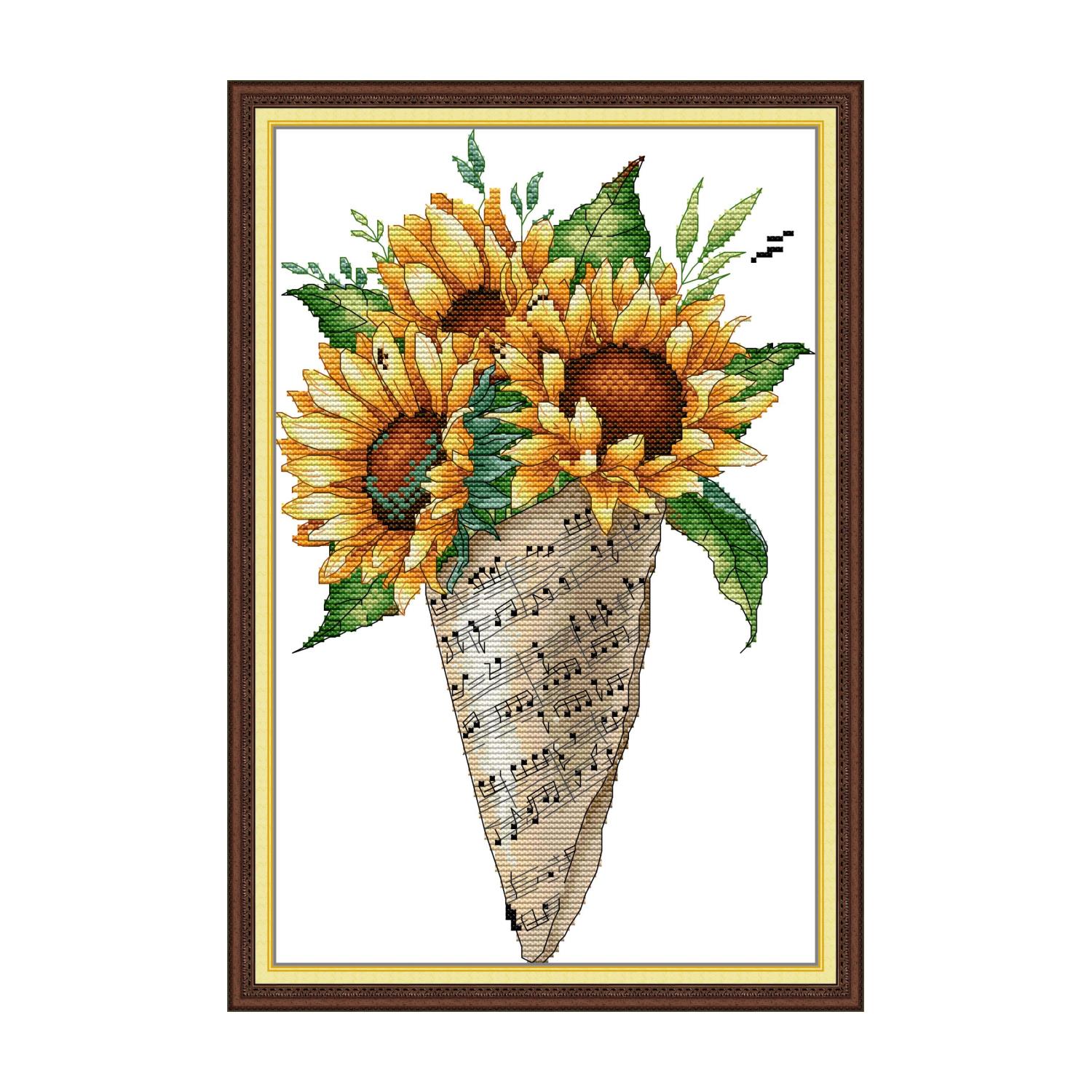 Floral cross stitch design of a sunflower bouquet wrapped in sheet music paper with green leaves
