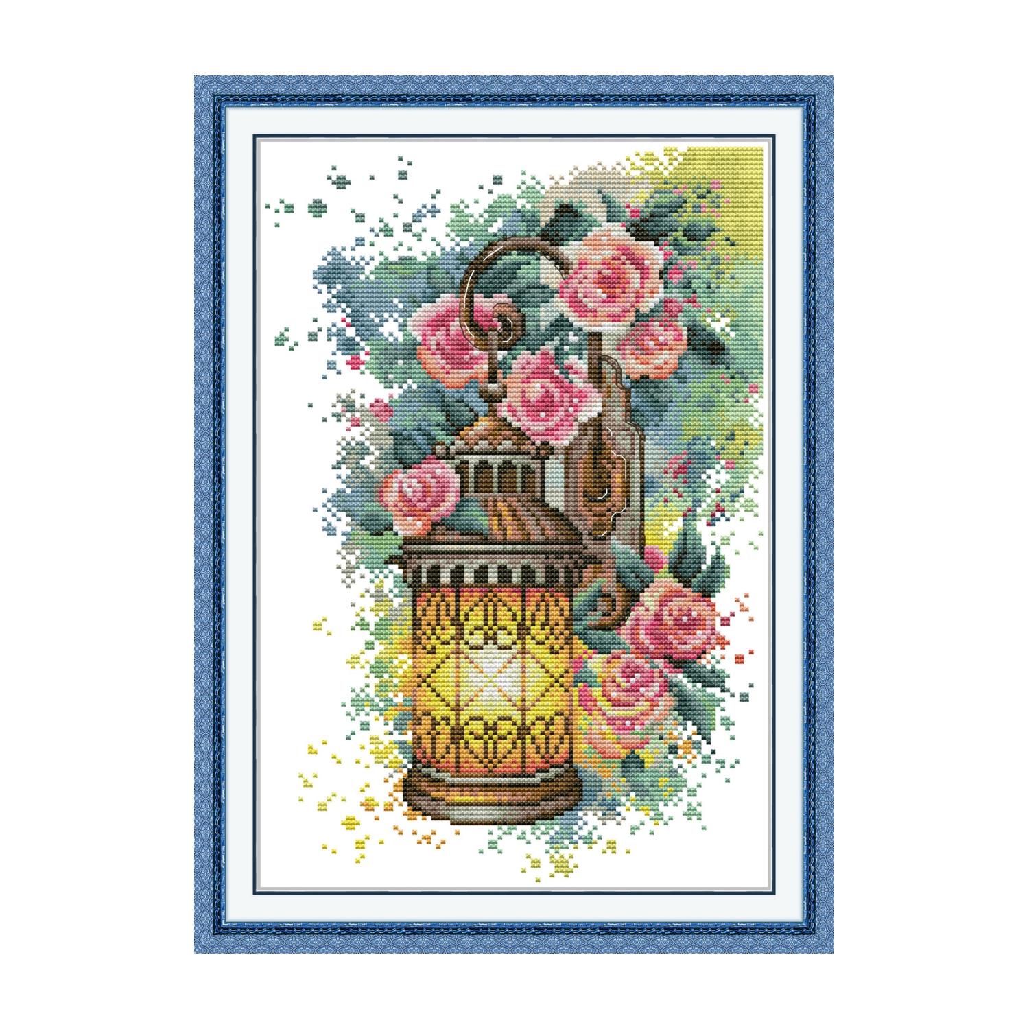 Rose cross stitch design of a vintage ornate lantern surrounded by pink roses and green leaves