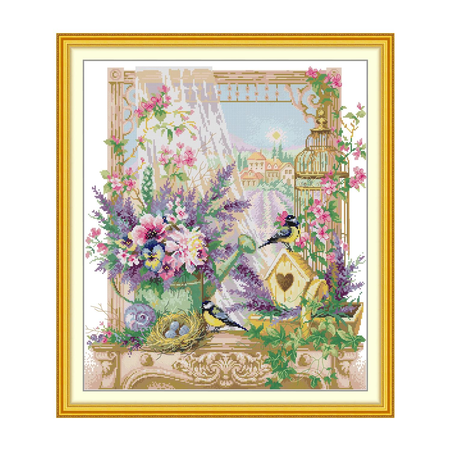 Bird cross stitch design of birds among lavender and pink flowers on a windowsill, with a bird nest and birdcage